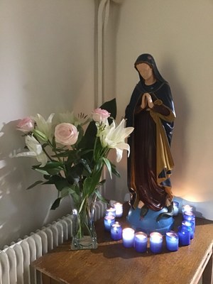 Statue de Marie bougies et bouquet
